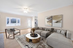 Virtually staged living room with a sectional sofa, armchair and coffee table